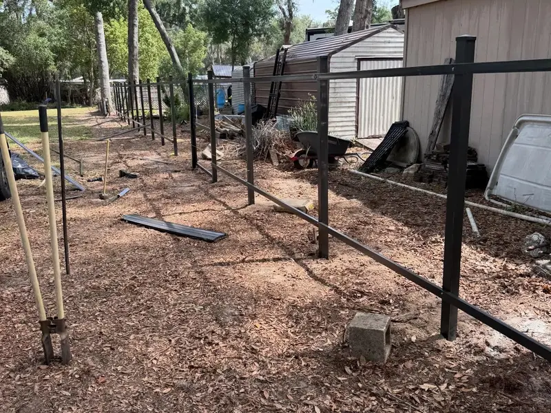 Fence repair job in progress in a Tampa yard