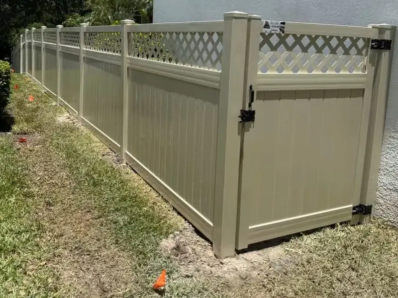 Tan vinyl fence with lattice top and matching gate installed in Tampa