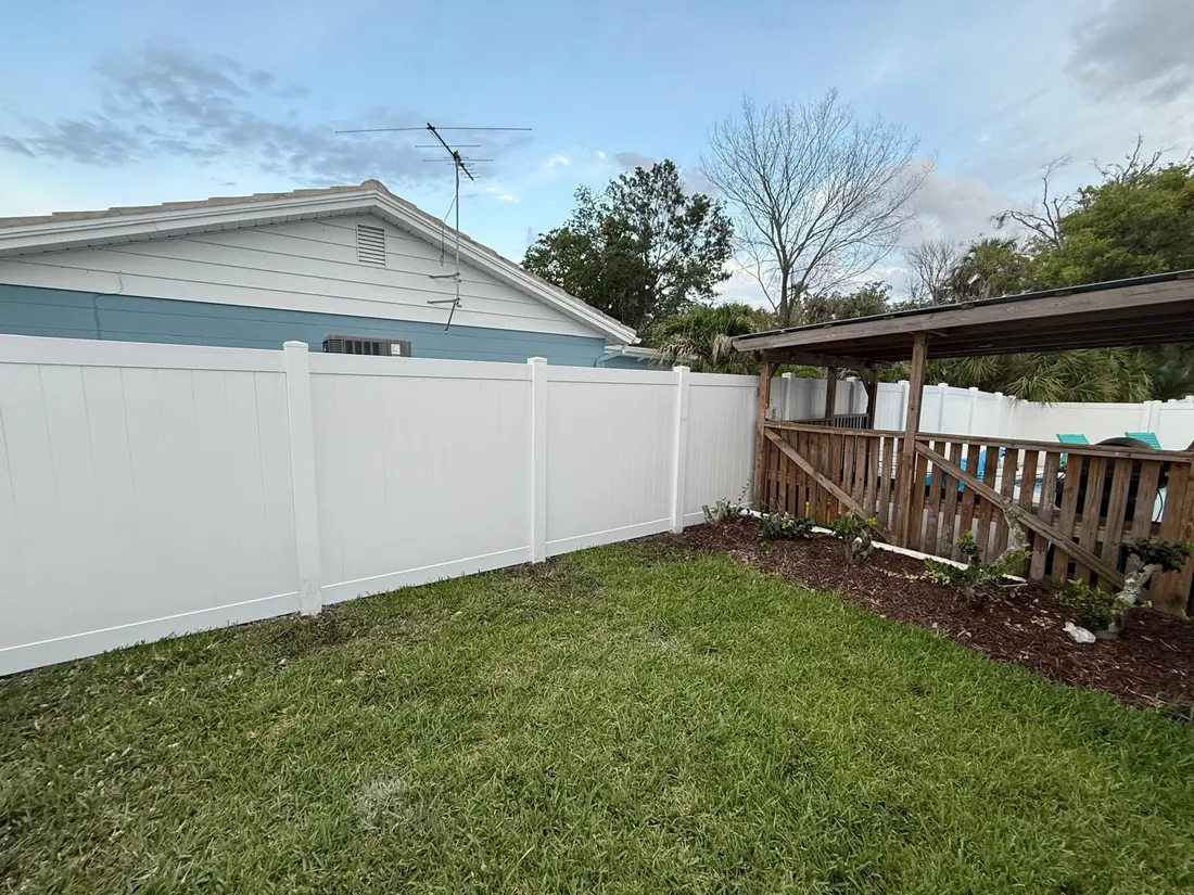 Vinyl fence line with new construction home in the background