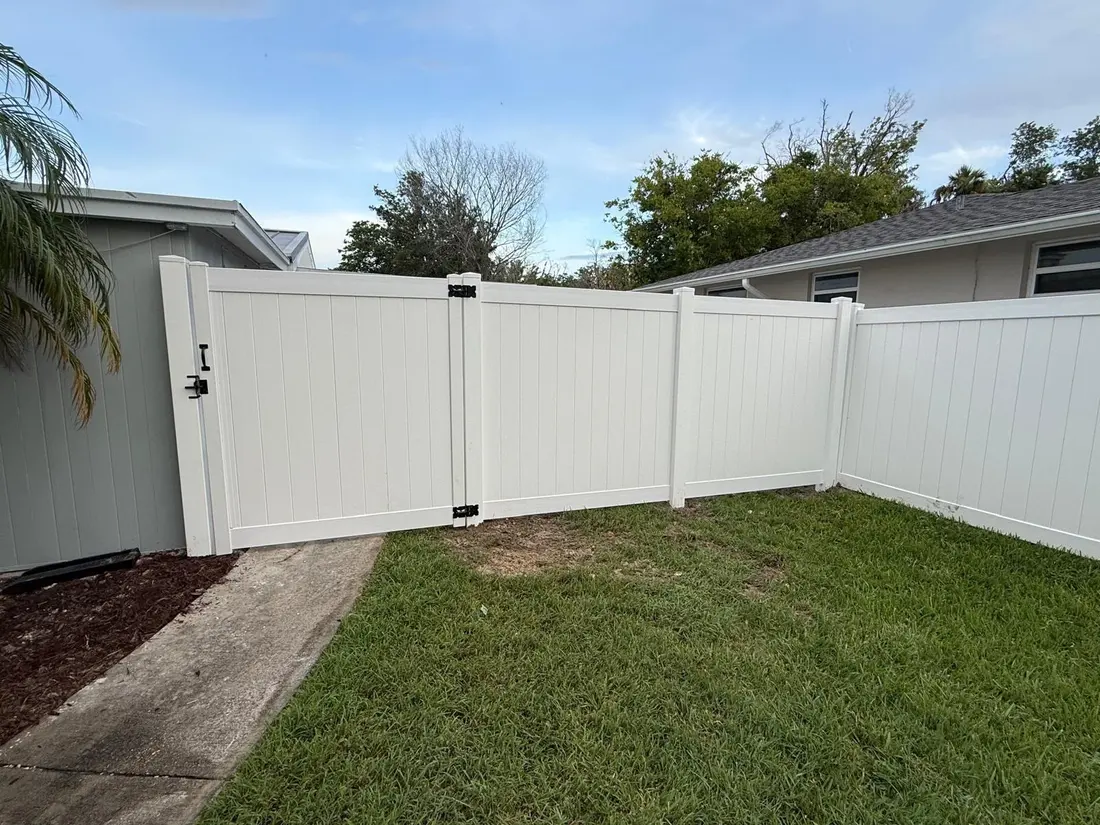 Vinyl fence installation along a property line