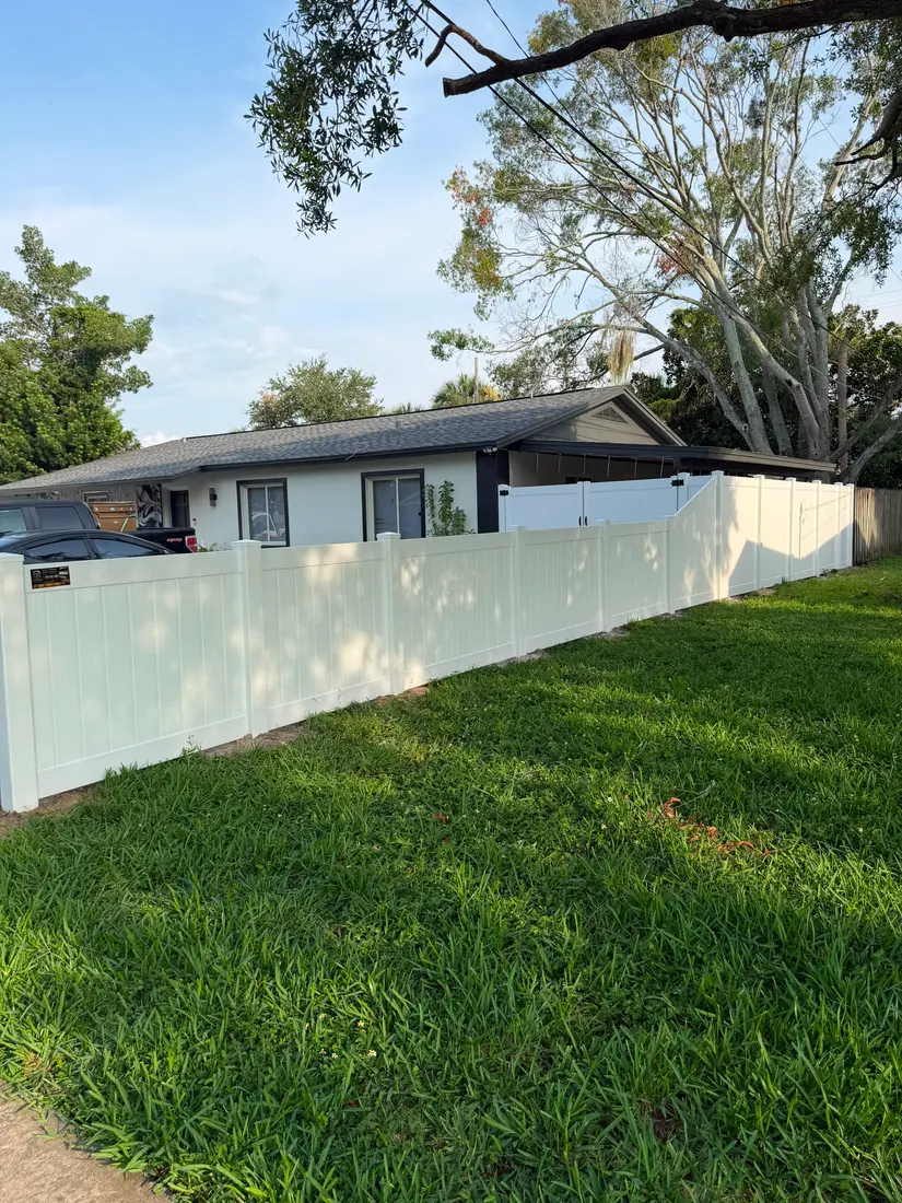 Vinyl fence installed along a shaded yard