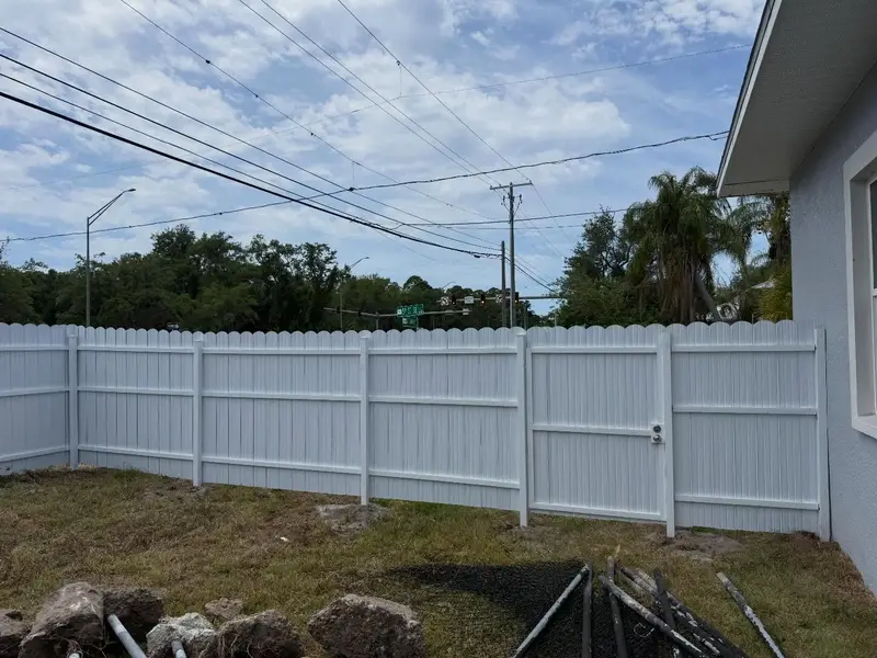 White vinyl privacy fence installation in a Tampa backyard