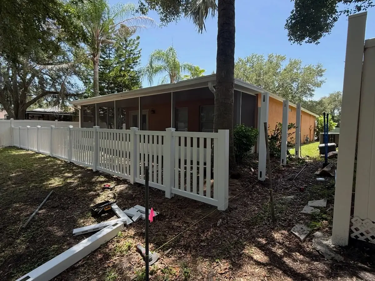 Daimon Fence work truck and trailer staged on a Tampa job site